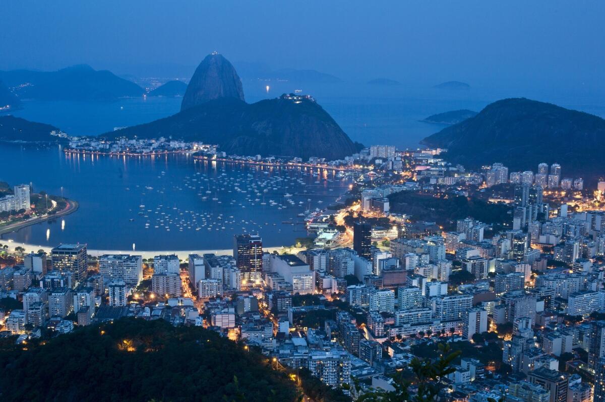 The night view of the Botafogo area shows Rio de Janeiro's Sugar Loaf mountain in background.