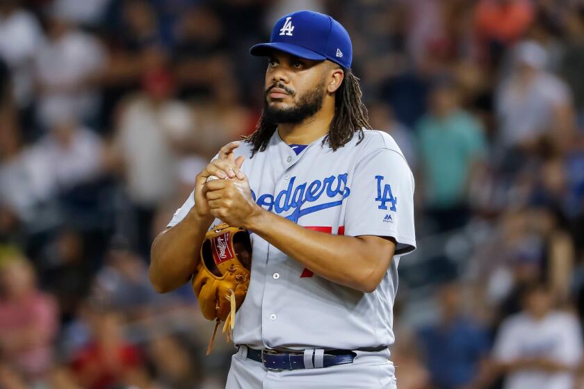 Mandatory Credit: Photo by ERIK S LESSER/EPA-EFE/REX (10348199ab) Los Angeles Dodgers relief pitcher Kenley Jansen rubs up a new baseball in the ninth inning of the MLB baseball game between the Washington Nationals and the Los Angeles Dodgers at Nationals Park in Washington, DC, USA, 26 July 2019. Los Angeles Dodgers at Washington Nationals, Washington, Dc, USA - 26 Jul 2019 ** Usable by LA, CT and MoD ONLY **