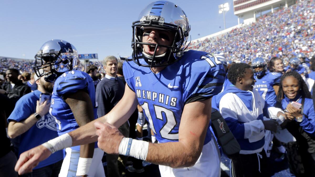 Quarterback Paxton Lynch (12) celebrates with teammates and fans after Memphis upset Mississippi on Saturday.