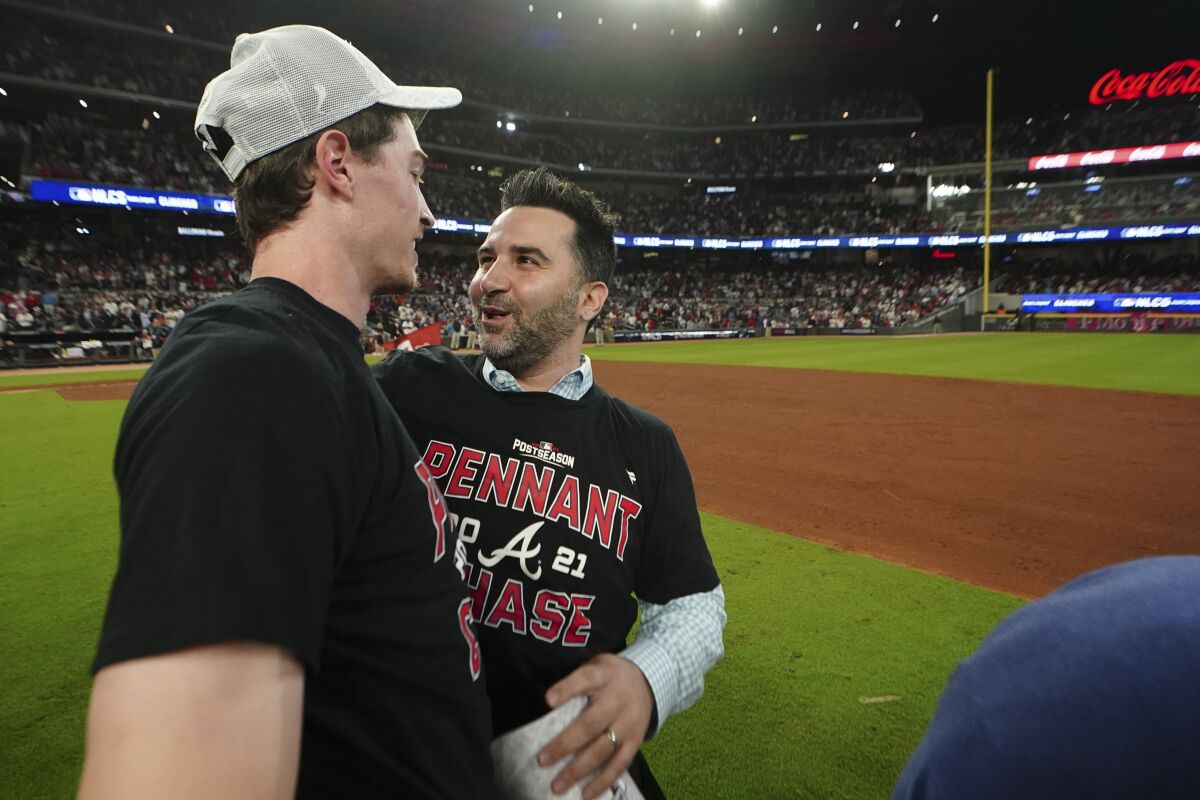 Atlanta Braves starting pitcher Max Fried, left speaks with Atlanta Braves General Manager Alex Anthopoulos after Game 4 of a baseball National League Division Series against the Milwaukee Brewers, Tuesday, Oct. 12, 2021, in Atlanta. The Atlanta Braves won 5-4 to advance to the NLCS. (AP Photo/John Bazemore)