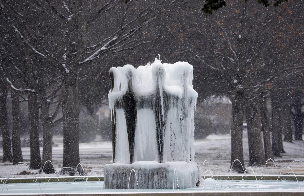 Ice forms on a water fountain as a light snow falls in Richardson, Texas, Thursday, Feb. 6, 2014. The National Weather Service recorded light snow Thursday in Austin, Dallas-Fort Worth, Abilene, Midland-Odessa, San Angelo and Lubbock. (AP Photo/LM Otero) ** Usable by LA and DC Only **