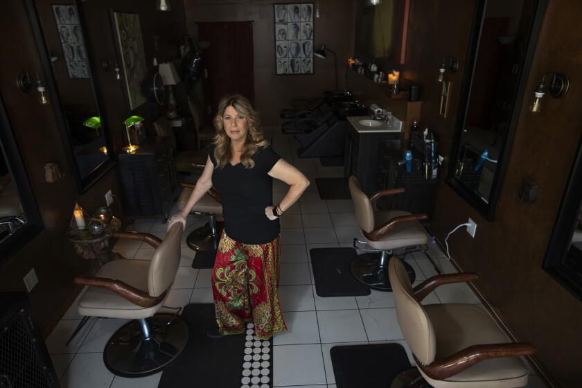 CULVER CITY, MAY 6, 2020: Elaina Wilcox, owner of Color & Craft Salon is photographed inside her empty salon on Main St. in Culver City. The salon has been closed since March 19, 2020 because of the coronavirus. Wilcox , who said that her rent is $3200 a month and doesn't have an income right now, fears that she will lose her salon. (Mel Melcon/Los Angeles Times)