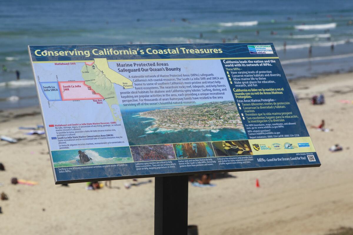 An interpretive sign at the foot of Diamond Street in Pacific Beach explaining the South La Jolla marine protected area (background) on August 9, 2019 in San Diego, California. 