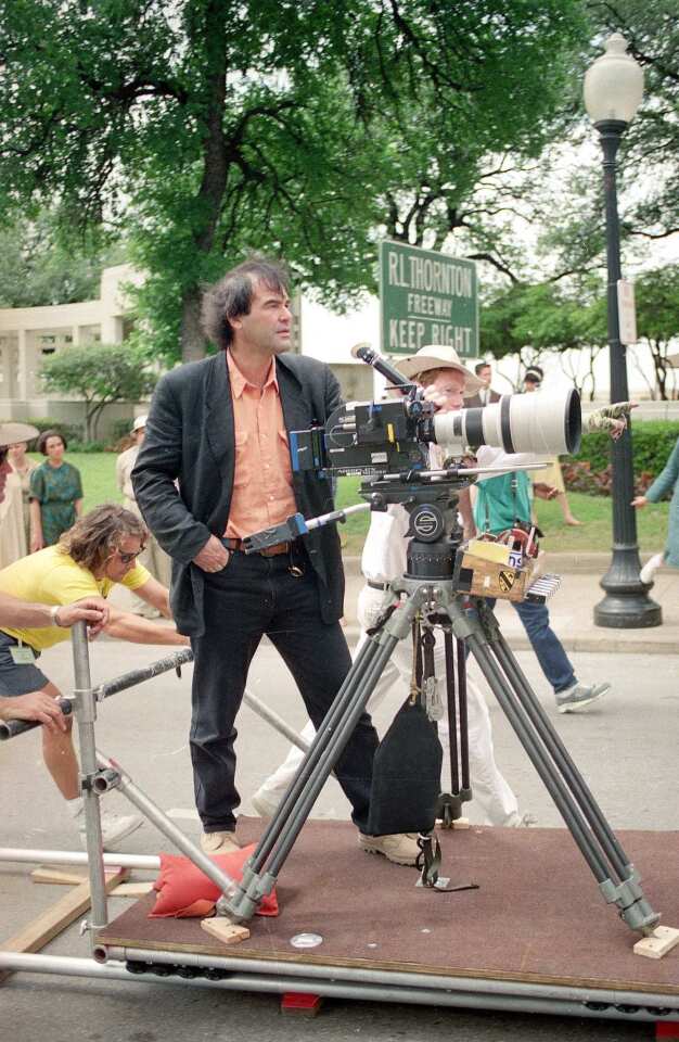 Two-time Oscar-winning film director Oliver Stone ("Platoon," "Born on the Fourth of July") gets a look at a camera angle for a motorcade scene in his film "JFK" in Dallas, Texas, on April 17, 1991.