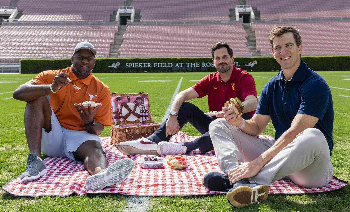 Vince Young, Matt Leinart and Eli Manning have a picnic on the Rose Bowl field.