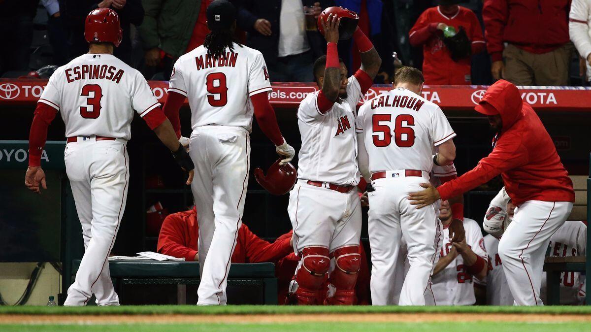 The Angels' Kole Calhoun (56) returns to the dugout after hitting a three-run home run Monday against the Chicago White Sox.