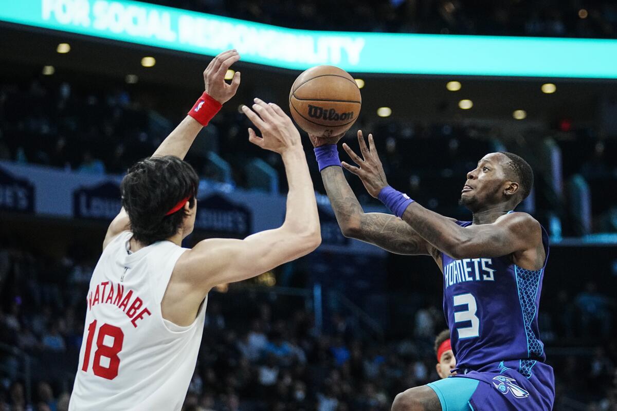 Charlotte Hornets guard Terry Rozier (3) shoots over the defense of Brooklyn Nets forward Yuta Watanabe (18) during the first half of an NBA basketball game, Saturday, Nov. 5, 2022, in Charlotte, N.C. (AP Photo/Rusty Jones)