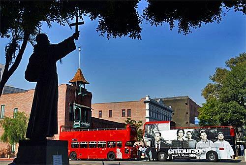 Starline Tours is running double-decker buses on tours of popular spots around Los Angeles for out-of-town visitors as well as locals. Here, the buses are parked on Olvera Street in downtown L.A. for the announcement about the new service.