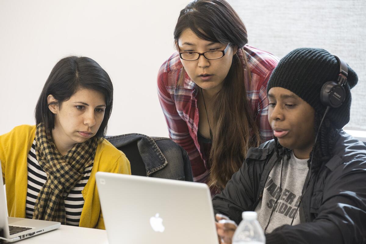 From left, Codetalk student Aimee Guzman, instructor Janice Lee, and student Erinn Bell during their web development class at the St. Joseph Center in Venice.
