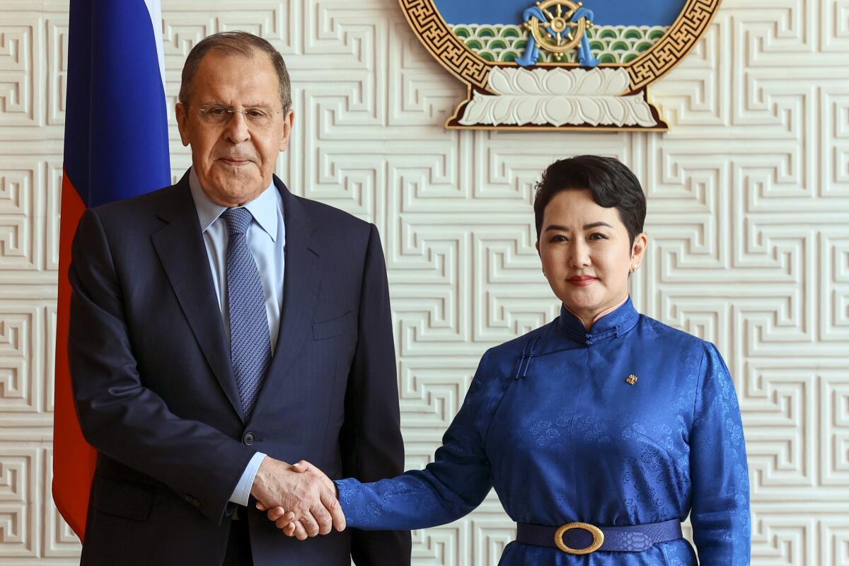 In this photo released by Russian Foreign Ministry Press Service, Mongolian Foreign Minister Batmunkh Battsetseg shakes hands with Russian Foreign Minister Sergey Lavrov prior to their talks in Ulaanbaatar, Mongolia, Tuesday, July 5, 2022. (Russian Foreign Ministry Press Service via AP)