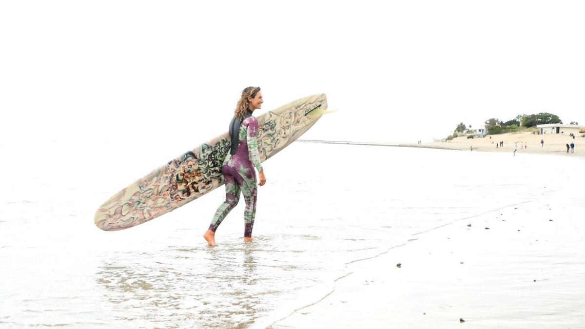 Longboarder Kassia Meador near her home break, First Point in Malibu. Meador is reimagining women's surf gear with her independent line, Kassia + Surf.