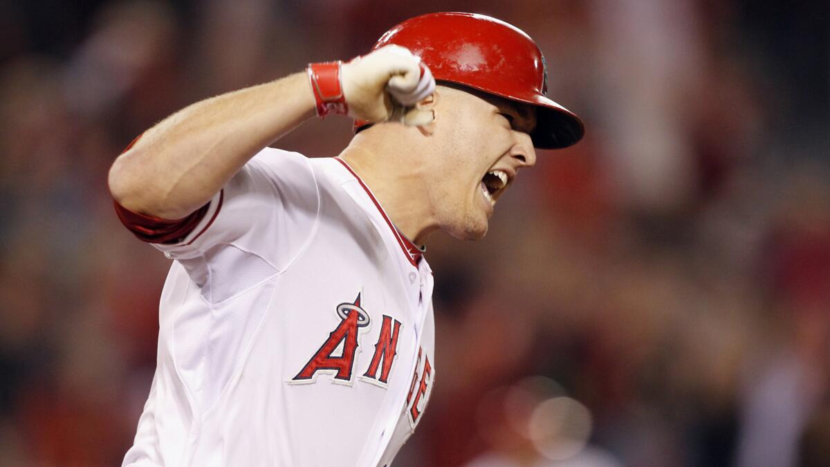 Angels center fielder Mike Trout celebrates after hitting a grand-slam home run during the eighth inning of the team's 6-5 comeback win over the Chicago White Sox on Saturday in Anaheim.