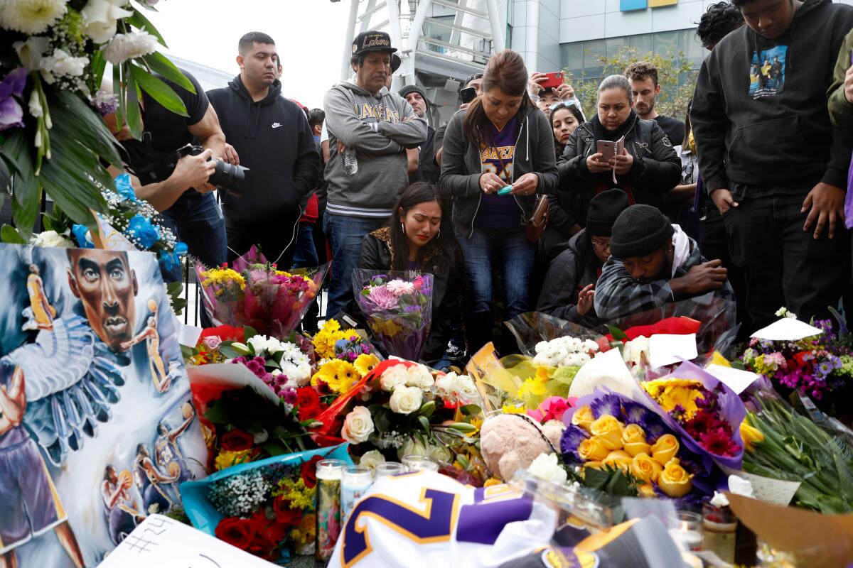 Fans gather near a memorial at Staples Center in downtown Los Angeles for Kobe Bryant, who died in a helicopter crash on Jan. 26.
