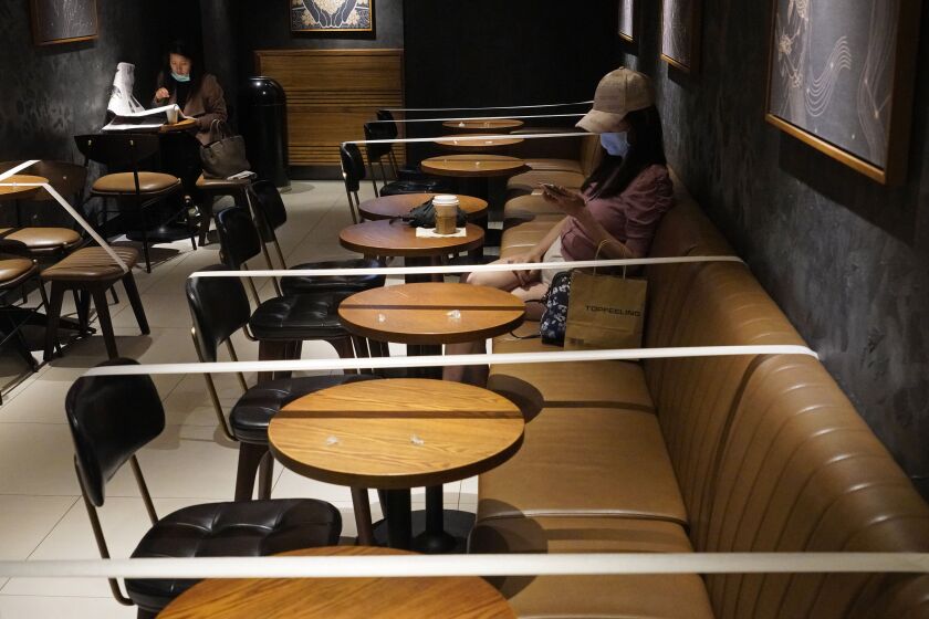HONG KONG: Tables and chairs are taped for the social distancing law enforcement to help curb the spread of the coronavirus at a Starbucks coffee shop in Hong Kong.