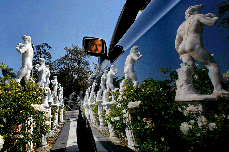 The Triforium,  Watts Towers, and statues of David in front of artist Norwood Young's home