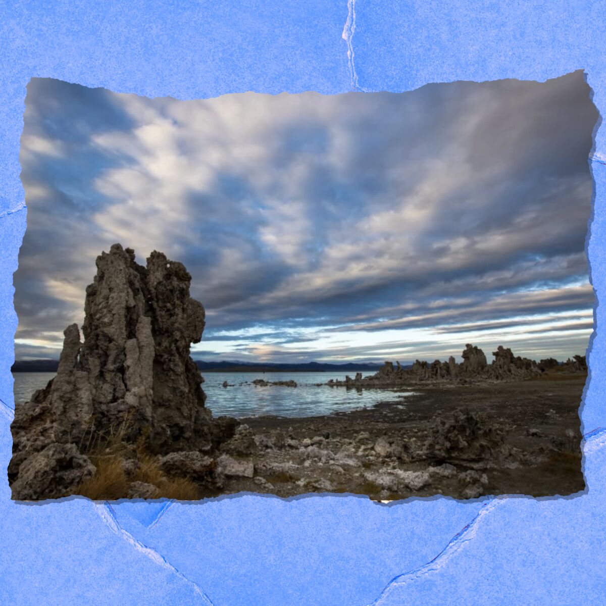 Passing clouds provide a striking backdrop for exposed tufa towers along the shore of Mono Lake 