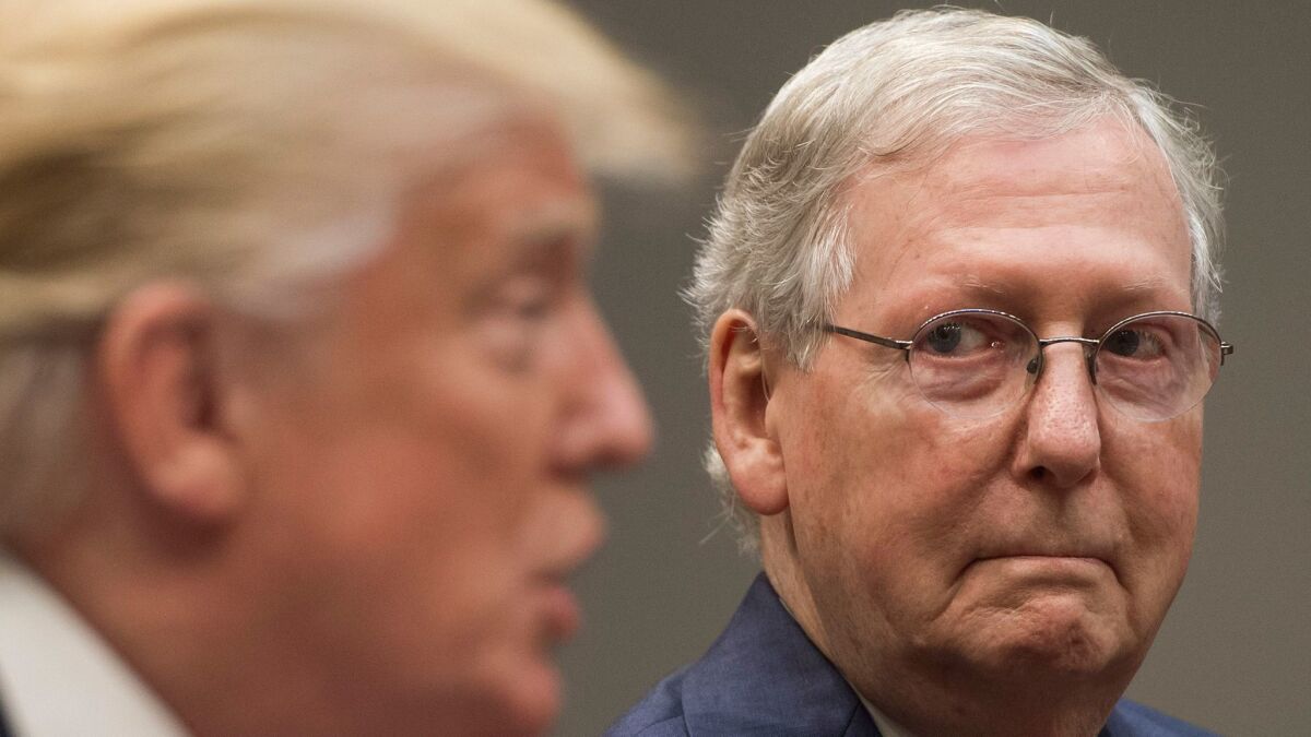 Senate Majority Leader Mitch McConnell listens as President Trump talks at a White House meeting Tuesday.