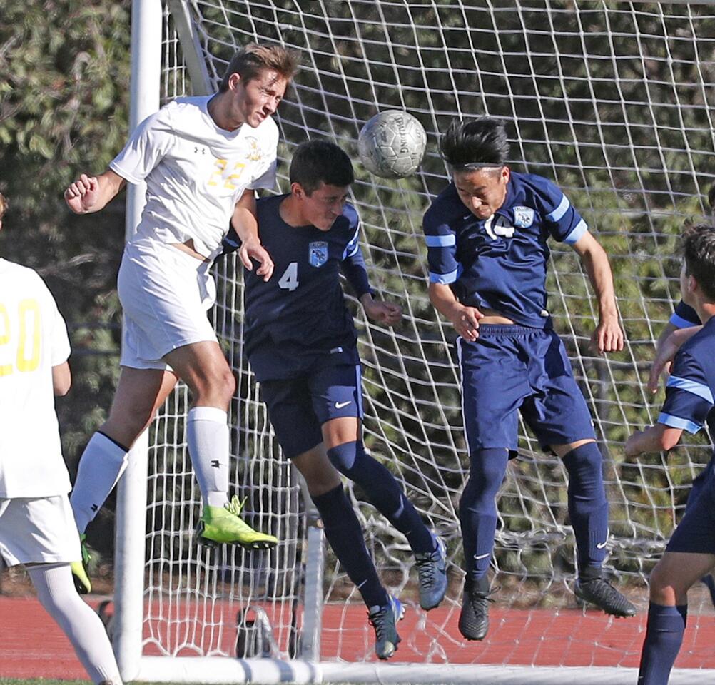Crescenta Valley's Brandon Carrillo and Yechan Kang work together to defend against a corner kick header by Brea Olinda's Ethan Stupin in a CIF Division III first round boys' soccer game at Crescenta Valley High School on Thursday, February 7, 2019. Brea Olinda won the game 3-0.