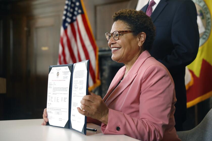 LOS ANGELES-CA-JULY 6, 2023: Mayor Karen Bass signs an ordinance intended to accelerate the building of affordable housing by eliminating the site plan review process for those projects at LA City Hall on July 6, 2023. (Christina House / Los Angeles Times)
