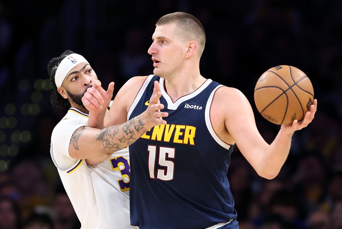 Lakers forward Anthony Davis tries to steal the ball from Nuggets center Nikola Jokic during Game 4.