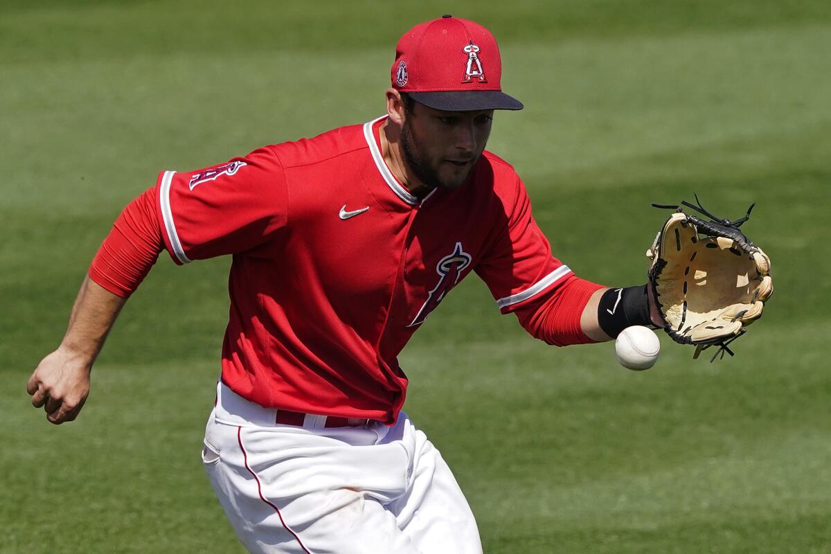 Angels' David Fletcher fields a base hit against the Oakland Athletics.