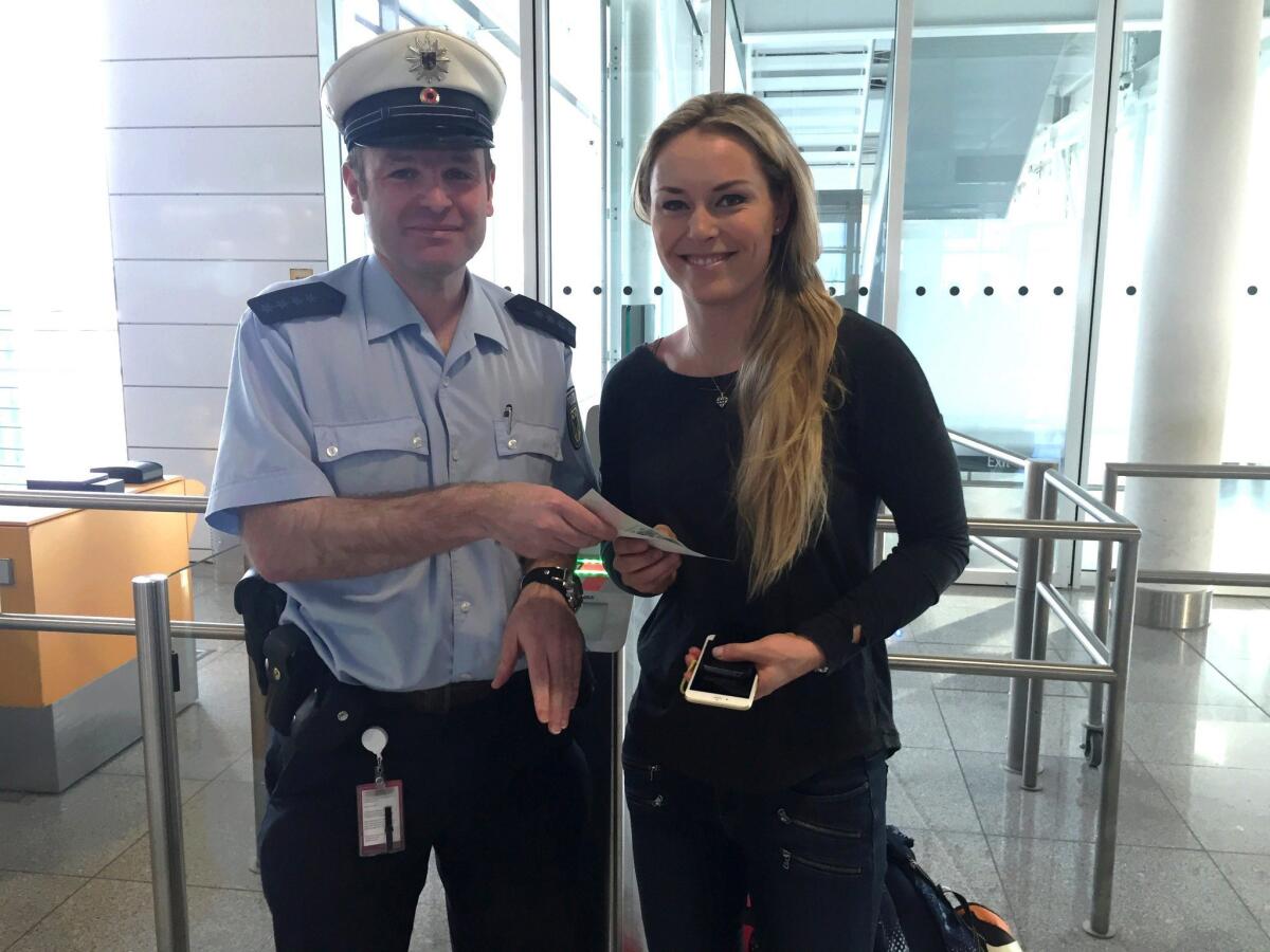 Lindsey Vonn receives a replacement passport from a German federal police officer Feb. 25 at the airport in Munich.