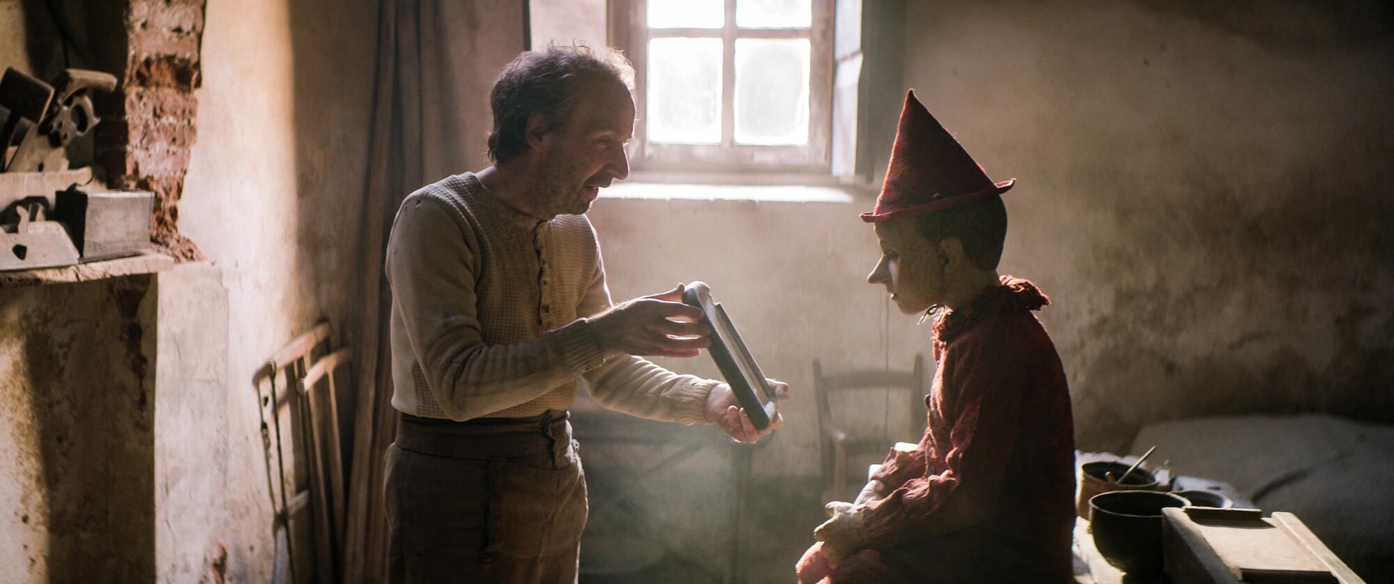 Roberto Benigni as Geppetto, and Federico Ielapi as Pinocchio, in "Pinocchio."