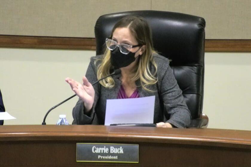 PYLUSD board president Carrie Buck explains the indoor mask requirement at a Jan. 11 meeting before adjourning on account of noncompliance.