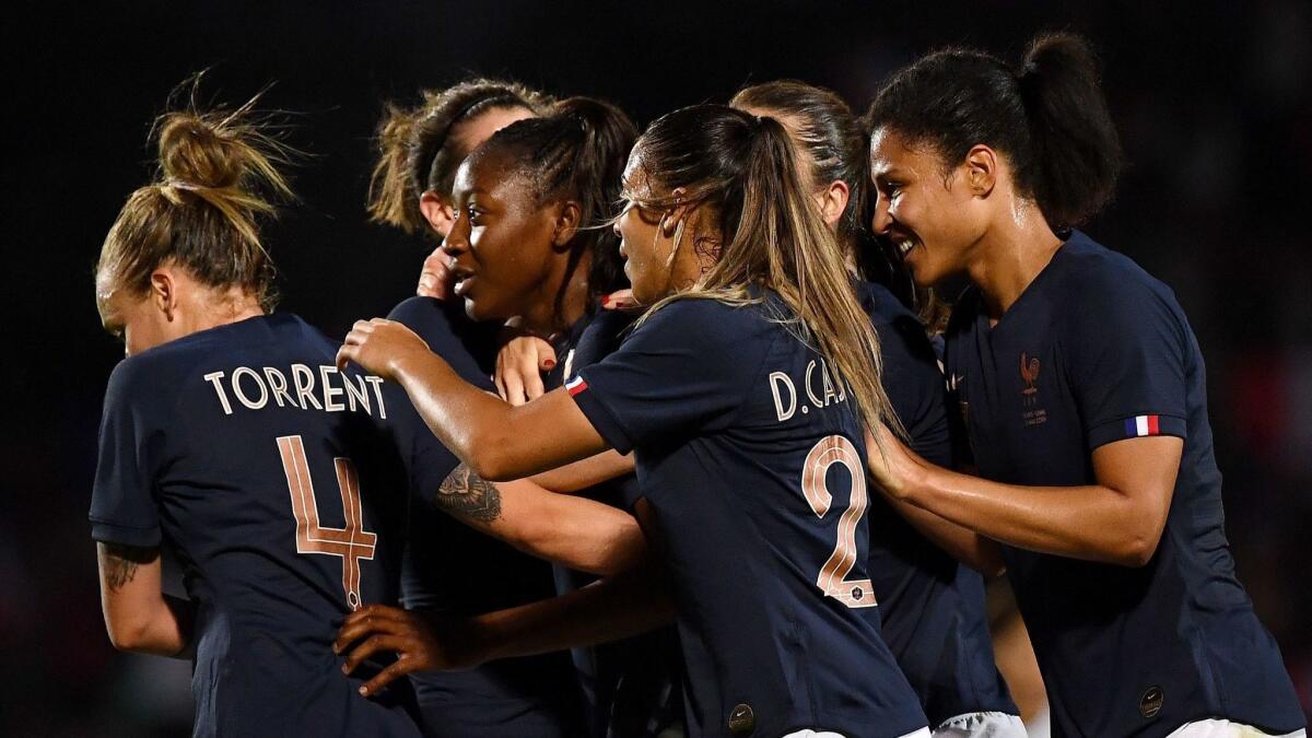 France midfielder Kadidiatou Diani, center, celebrates with teammates after scoring her team's second goal during an international friendly match against China on May 31.