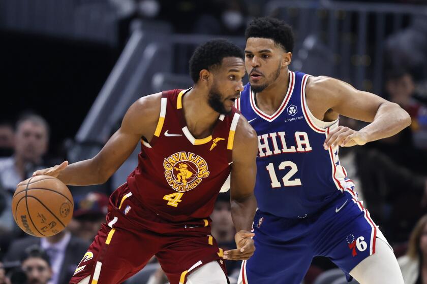 Cleveland Cavaliers' Evan Mobley (4) plays against Philadelphia 76ers' Tobias Harris (12) during the second half of an NBA basketball game, Wednesday, March 16, 2022, in Cleveland. (AP Photo/Ron Schwane)