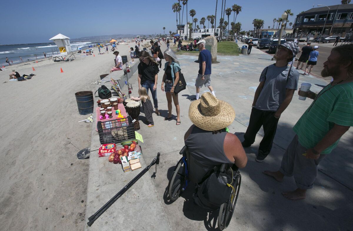 Several vendors set up shop along the boardwalk at the foot of Newport Avenue at Abbott Street in Ocean Beach in 2019.