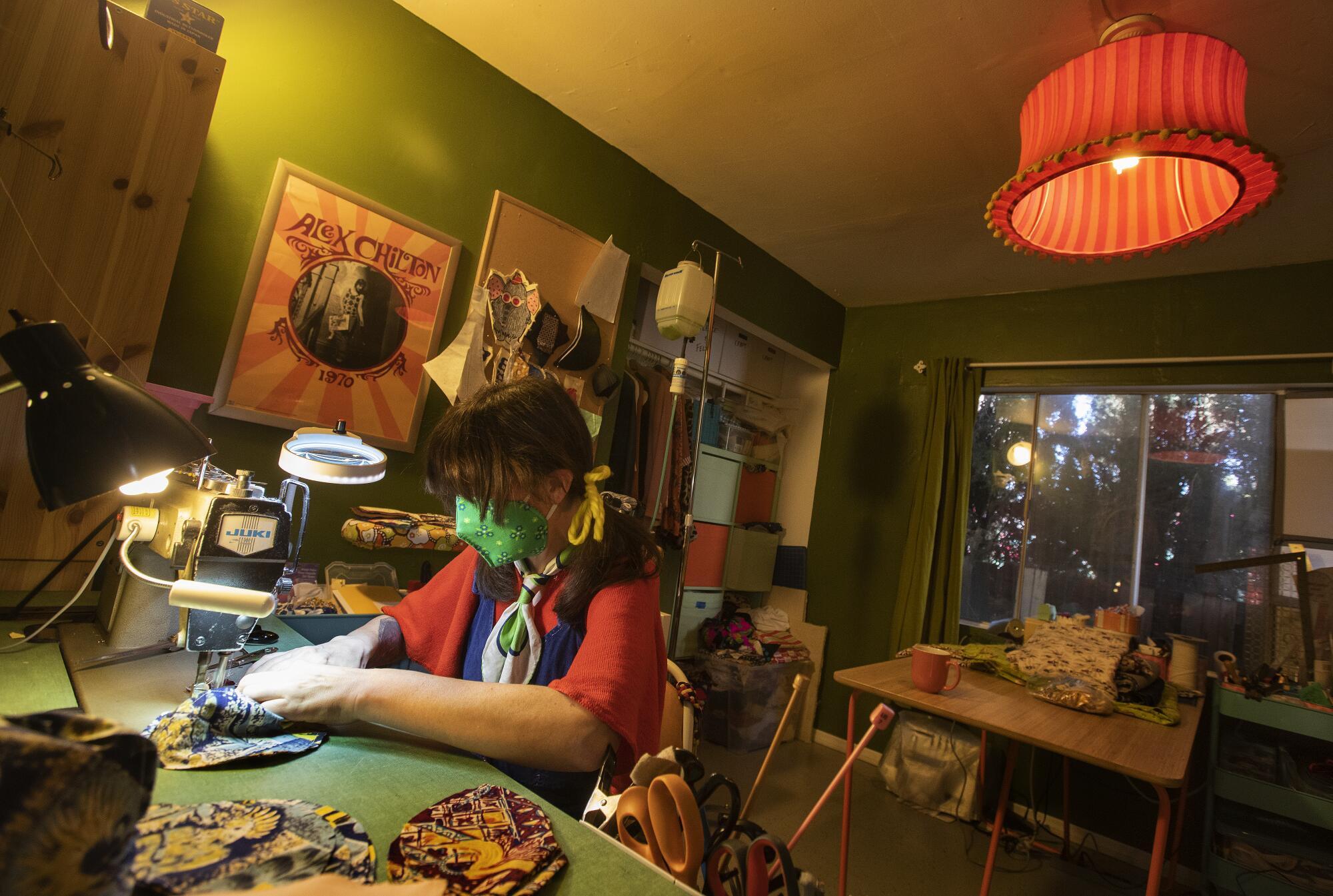 Kacey Barnes sews masks at her home in Echo Park. Barnes, who lost her job doing set tailoring and costume building for the film and television industry, said she averages making 50 masks a day, seven days a week.