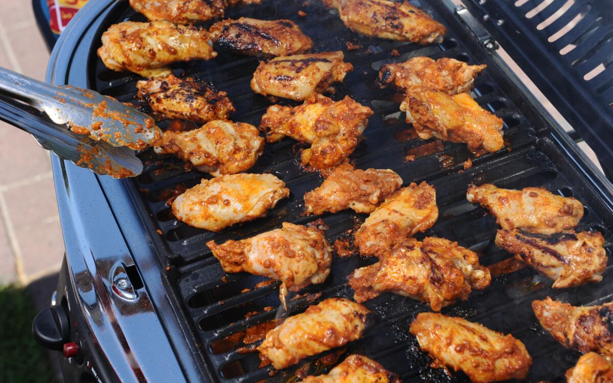 Grilled chipotle wings laid out on the grill.