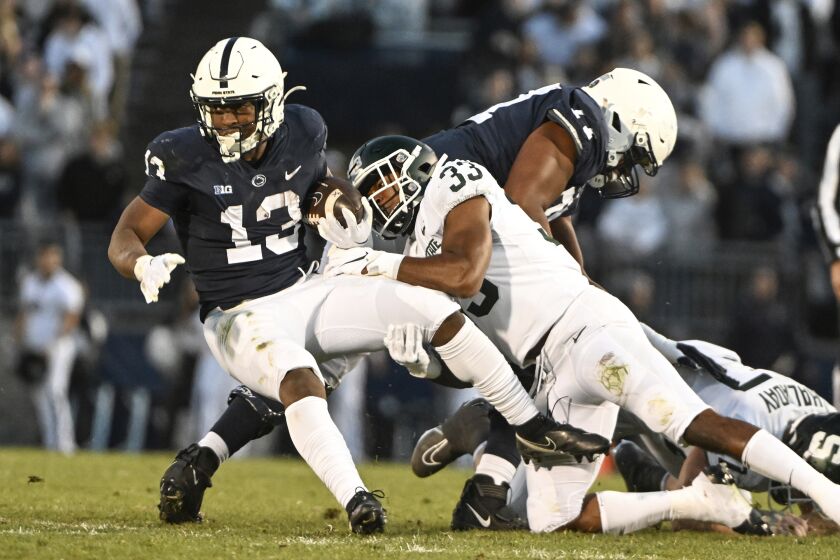 Michigan State cornerback Kendell Brooks (33) tackles Penn State running back Kaytron Allen (13) during the first half of an NCAA college football game Saturday, Nov. 26, 2022, in State College, Pa. (AP Photo/Barry Reeger)