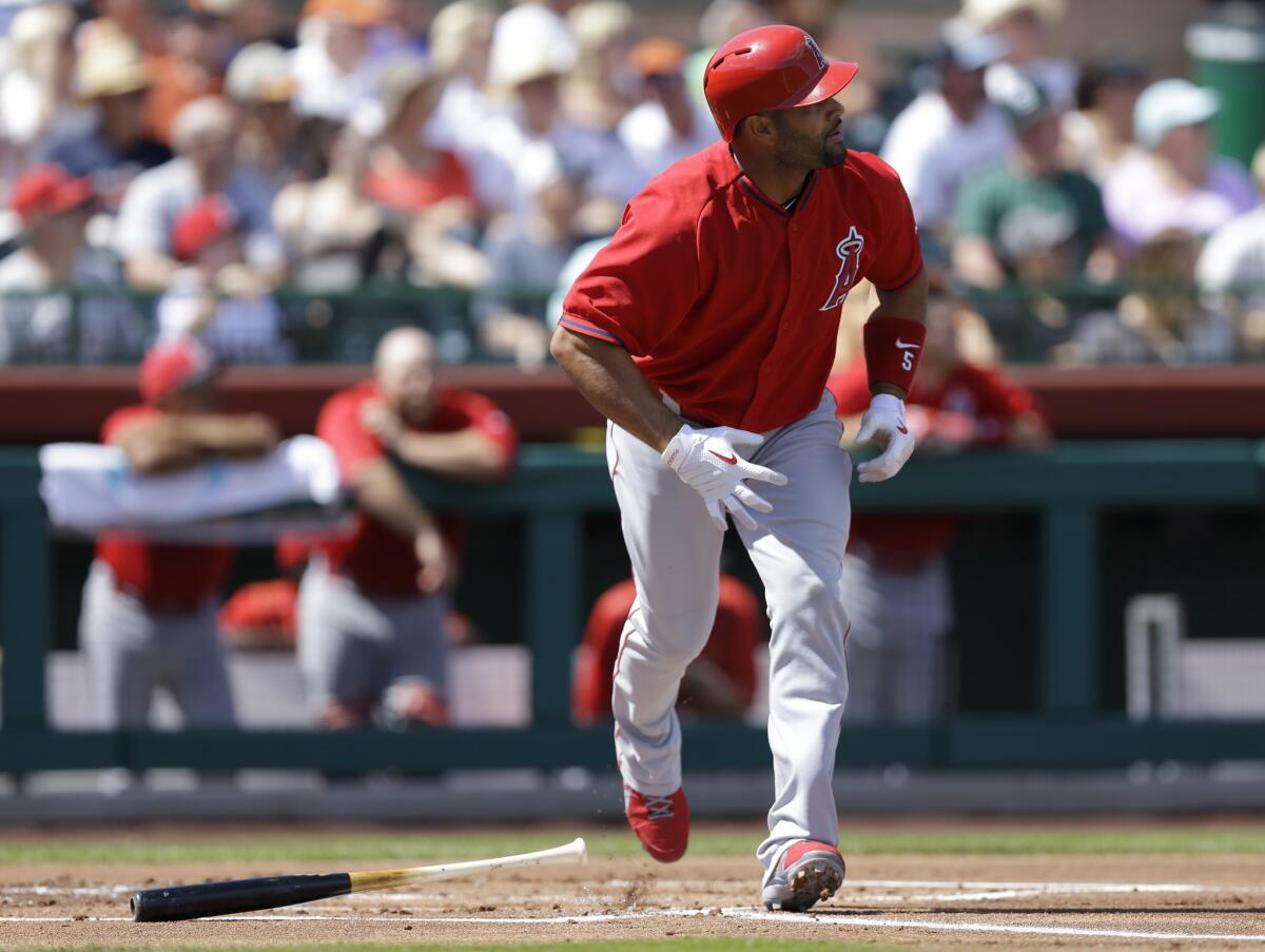 Angels first baseman Albert Pujols watches his home run sail over the fence during a spring training game last week.