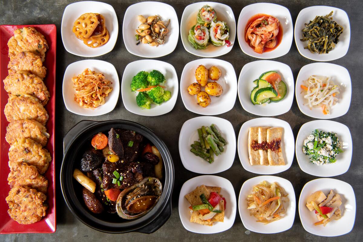 Banchan from Soban in many small white dishes, arranged in a grid