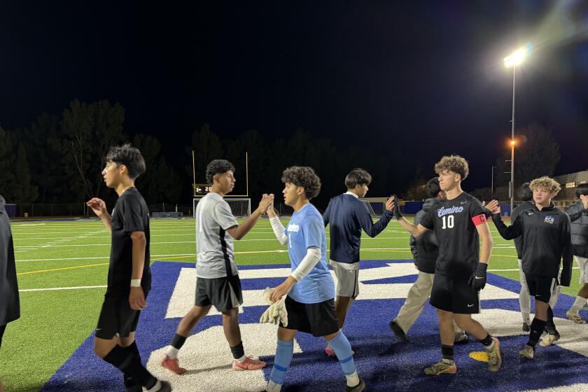 El Camino Real goalie Anthony Salmeron (1) and teammate Jonathan Rabinovitch (10) shake hands with Birmingham players.
