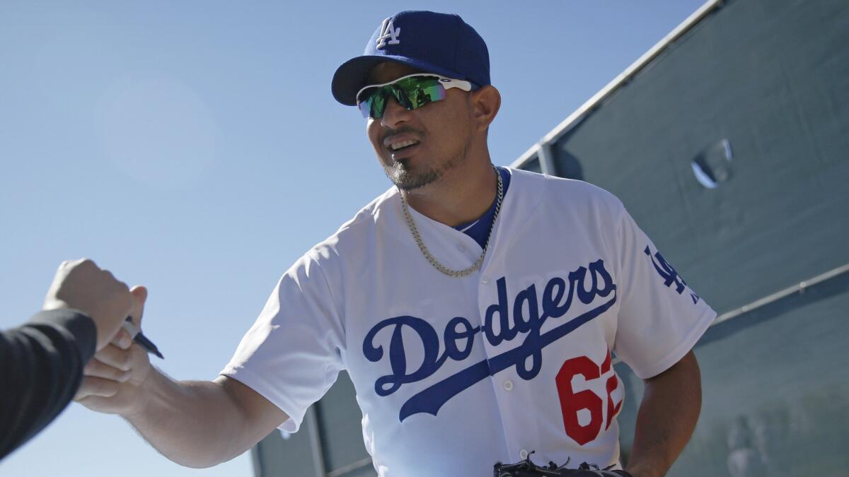 Dodgers reliever Joel Peralta signs autographs for fans after a spring training workout session in Phoenix on Feb. 25. Peralta is returning from the disabled list.