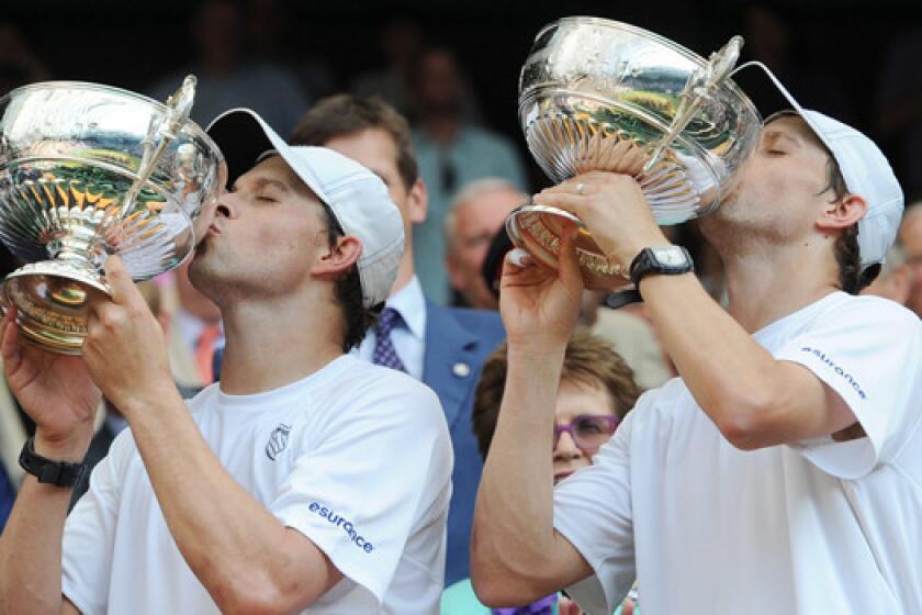 Bob, left, and Mike Bryan celebrate after winning the Wimbledon men's doubles championship on Saturday.