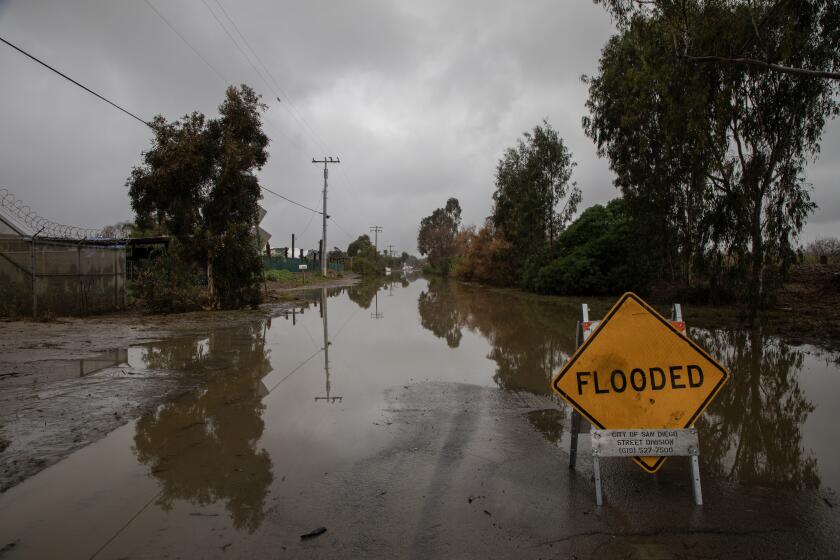 Hollister Street floods near Monument Road on February 5, 2024 in San Diego, California.