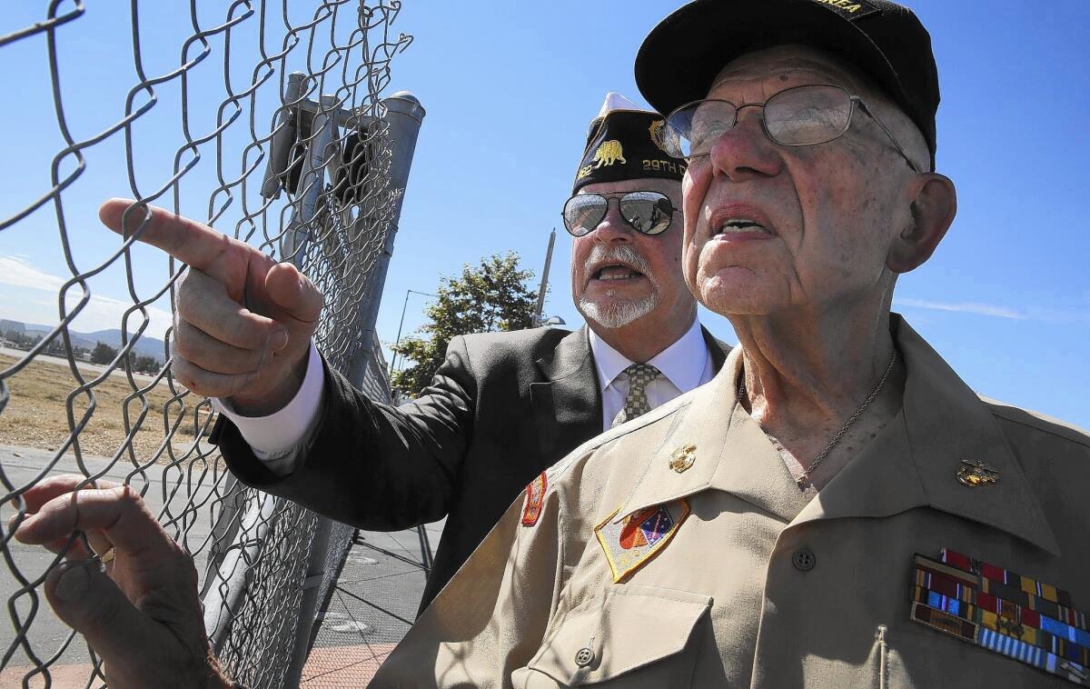 Bill Cook, left, chairman of the Orange County Veterans Memorial Park committee, talks with former Major Neil Reich about the proposed location of a new veterans cemetery at the former El Toro Marine Base.