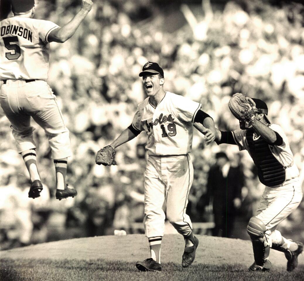 From left, Brooks Robinson, Dave McNally and Andy Etchebarren celebrate after the Orioles shut out the Dodgers, 1-0, to sweep the 1966 World Series.
