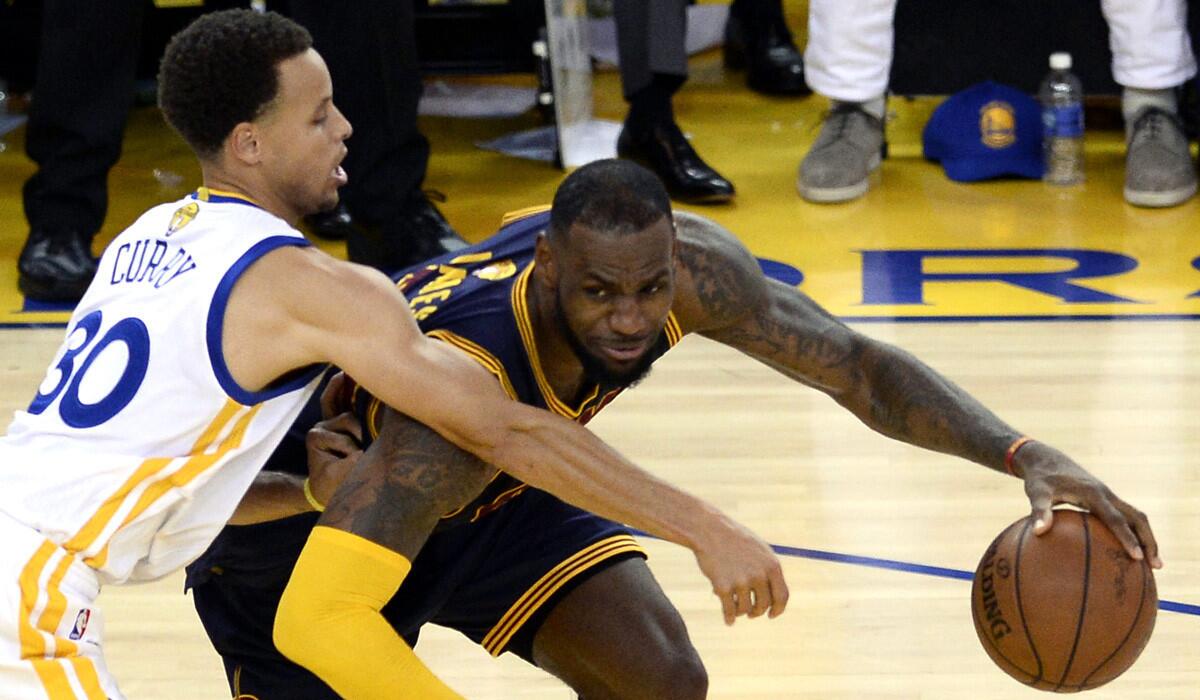 Cleveland Cavaliers' LeBron James drives against Golden State Warriors' Stephen Curry in Game Two of the NBA Finals on Sunday. The series is tied 1-1.