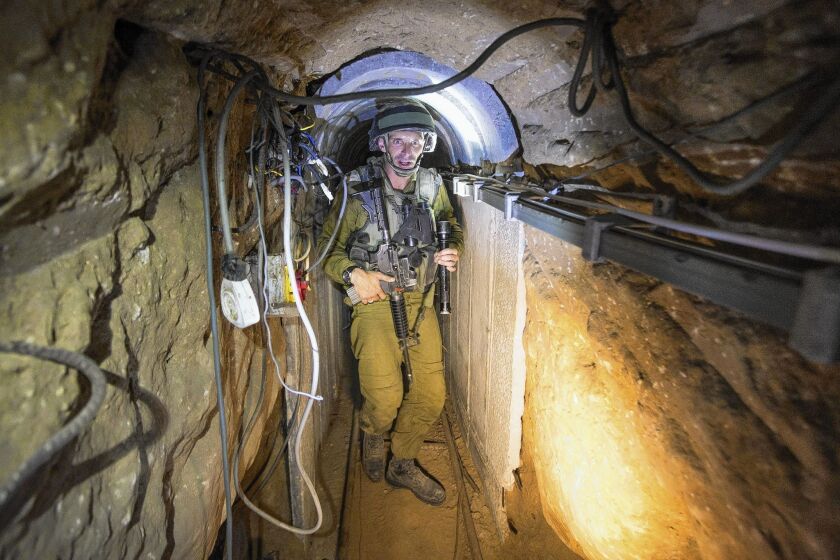 An Israeli army officer gives journalists a tour of a tunnel officials said was used by Palestinian militants for cross-border attacks.