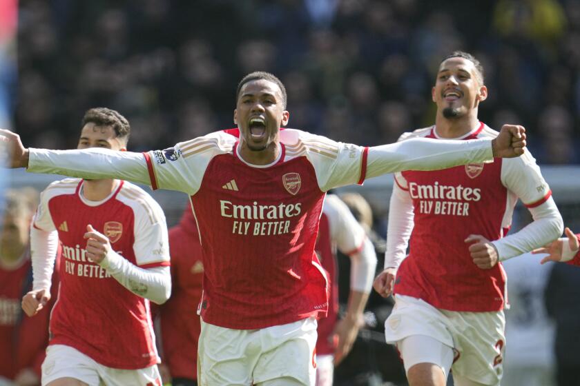 Arsenal's Gabriel celebrates with team mates at the end of the English Premier League soccer match between Tottenham Hotspur and Arsenal at the Tottenham Hotspur Stadium in London, England, Sunday, April 28, 2024. (AP Photo/Kin Cheung)