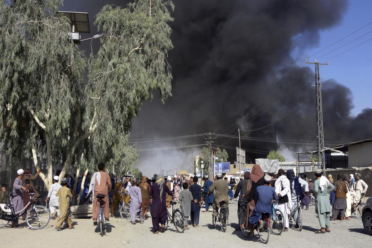 Plumes of smoke rise into the sky after fighting between the Taliban and Afghan security personnel in Kandahar.