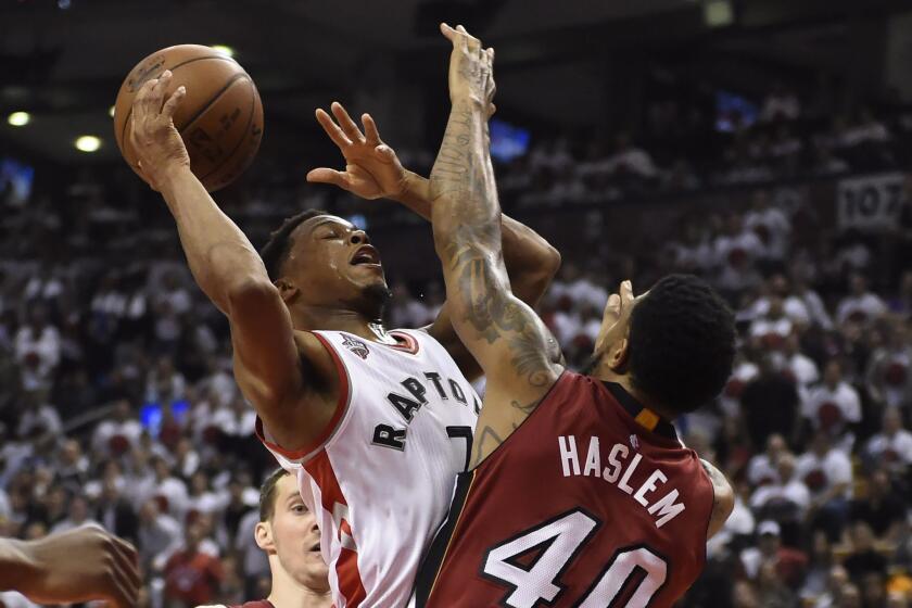 Raptors guard Kyle Lowry is fouled by Heat forward Udonis Haslem, right, during the first half of Game 7 of the Eastern Conference semifinals on May 15.