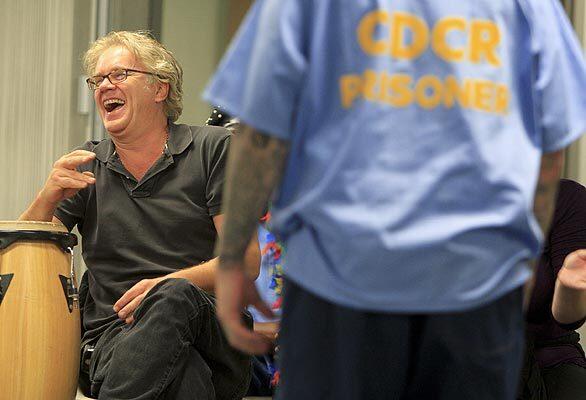 Actor Tim Robbins laughs while inmates perform wearing full face paint and makeup at the California Rehabilitation Center in Norco. Robbins and the Actors' Gang work directly with the inmates while they develop their characters and have a little fun improvising.