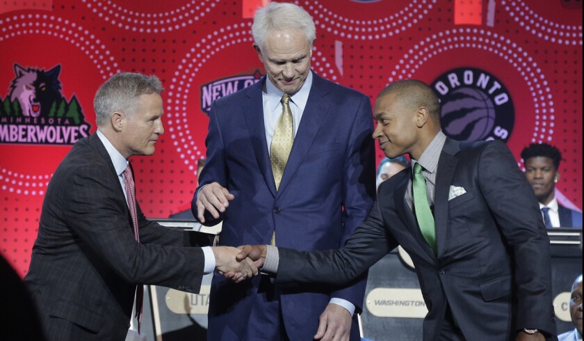 Philadelphia 76ers head coach Brett Brown, left, is congratulated by Boston Celtics guard Isaiah Thomas, right, and Los Angeles Lakers general manager Mitch Kupchak after the 76ers won the top draft pick during the NBA draft lottery on Tuesday.