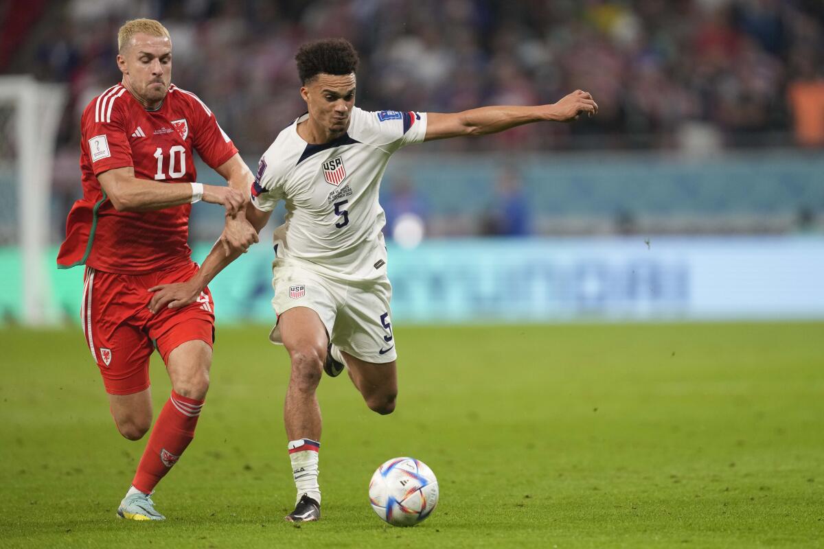 U.S. defender Antonee Robinson and Wales midfielder Aaron Ramsey battle for the ball in the first half.